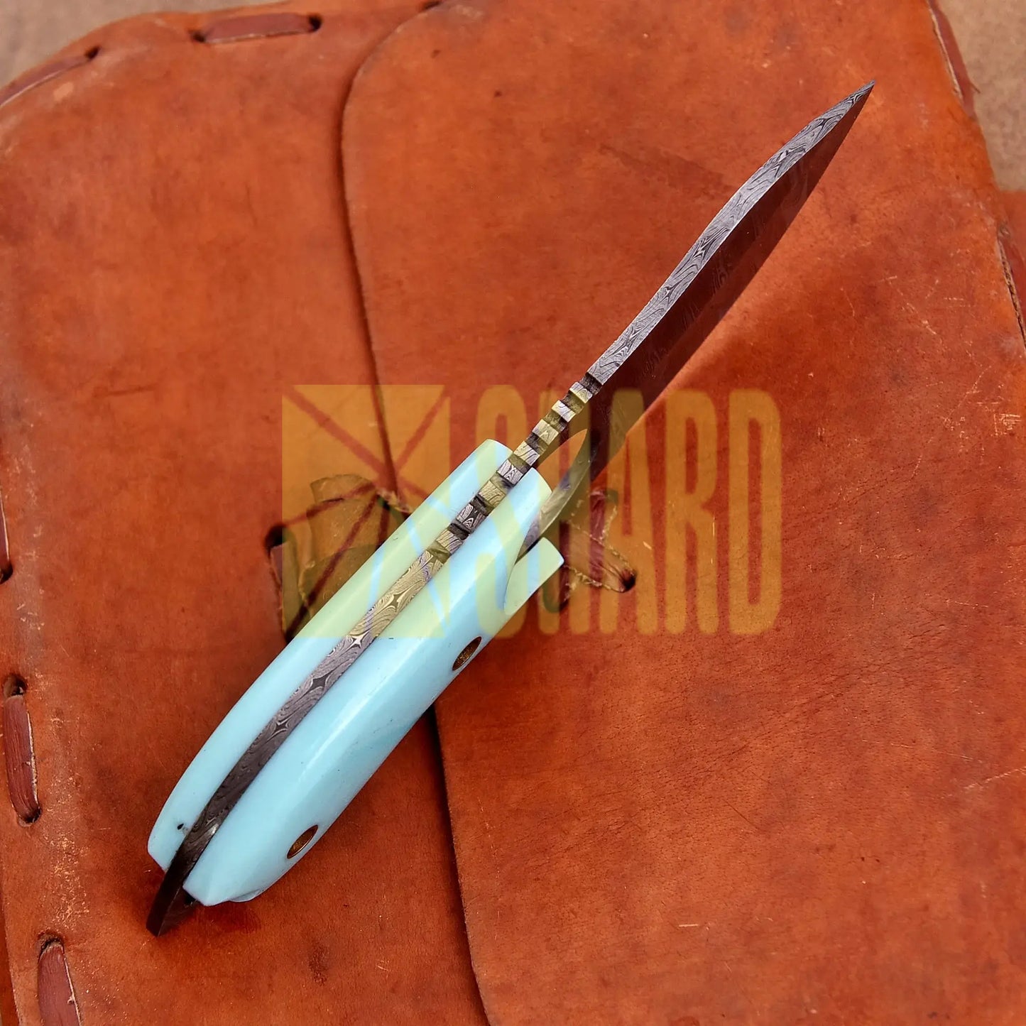 Hand-forged Damascus steel collectible with raindrop pattern and light blue resin handle – Raindrop Mini gift piece