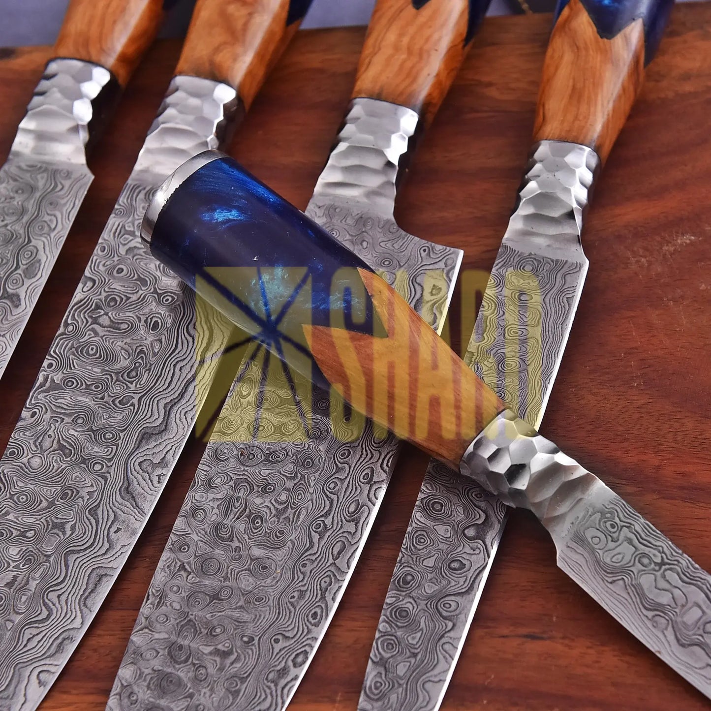 Handmade Oceanhearth Damascus Chef Set with natural wood and deep ocean resin handles – 5-piece collectible culinary set with leather roll.