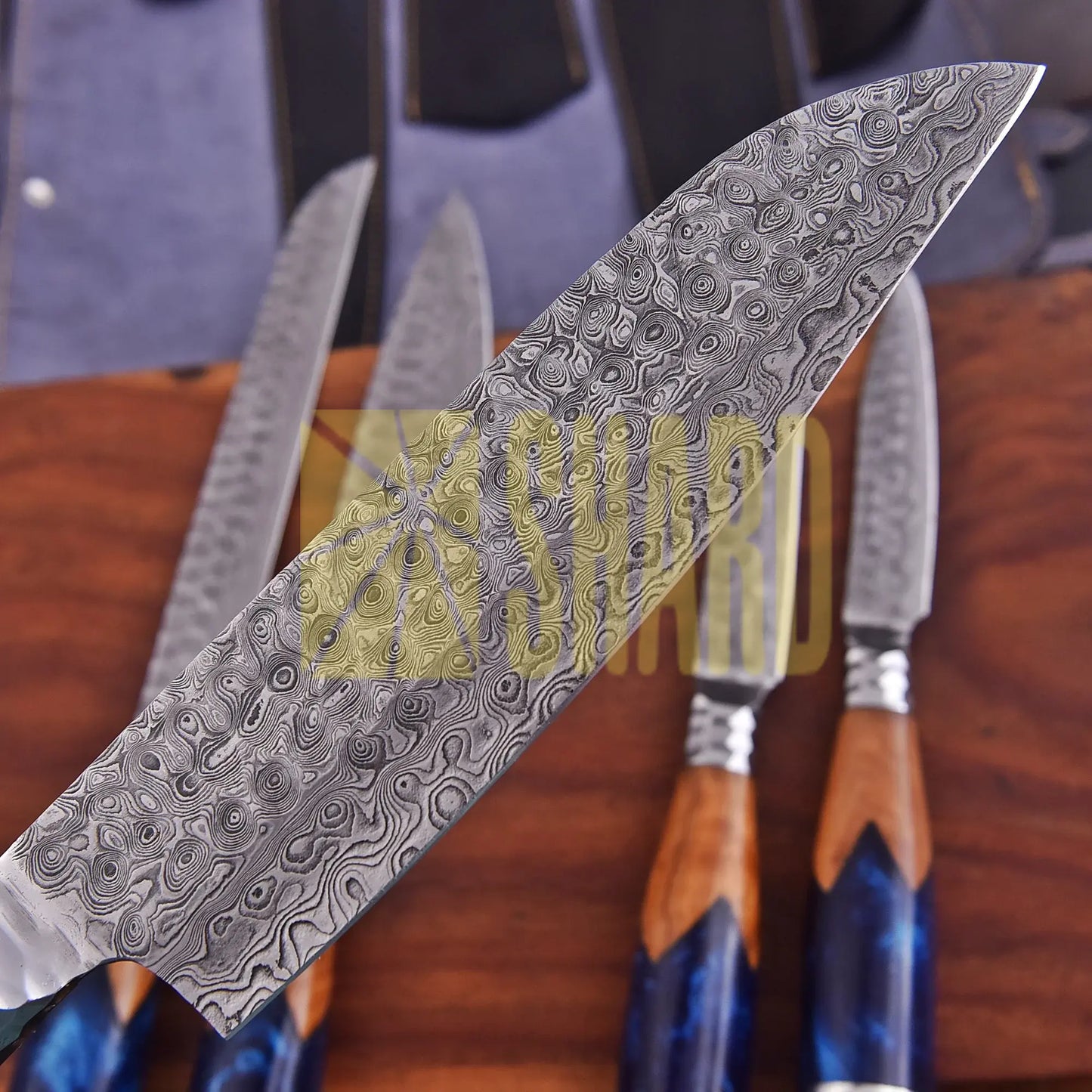 Handmade Oceanhearth Damascus Chef Set with natural wood and deep ocean resin handles – 5-piece collectible culinary set with leather roll.
