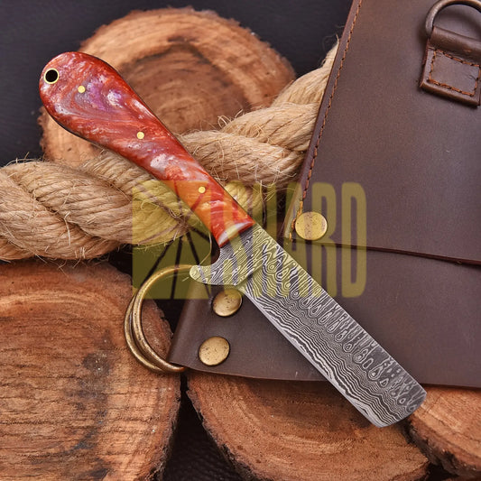 Handcrafted Riverstone Guppy kitchen collectible with Damascus raindrop pattern and stone resin handle