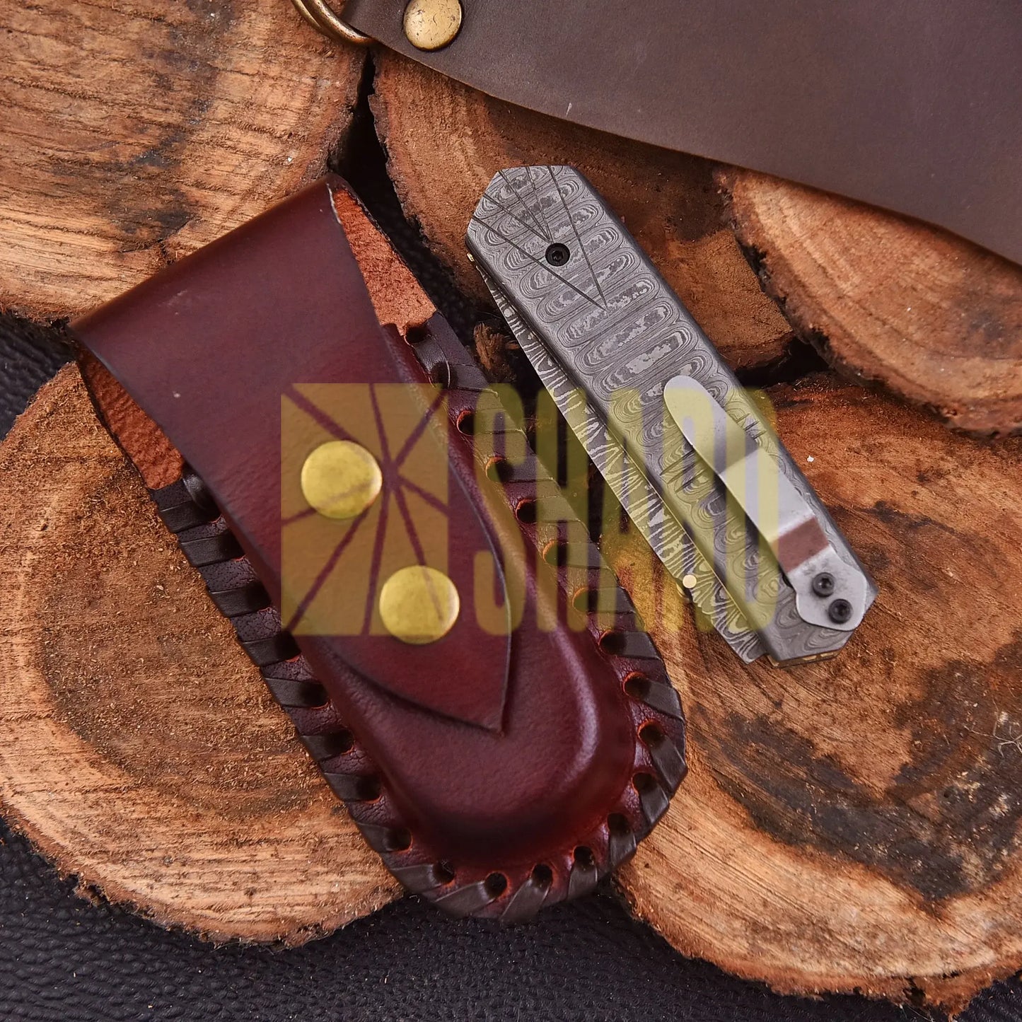 Crimson Crest Damascus Steel Folding Utility Craft with raindrop and wave pattern, featuring folding design and belt buckle clip.