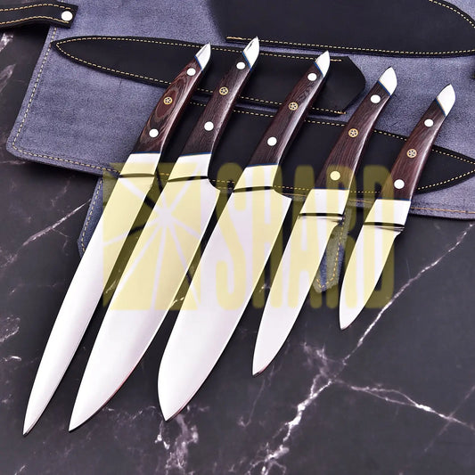Handmade 5-piece chef set with clear steel finish, polished bolster, rosewood handles, and leather roll.