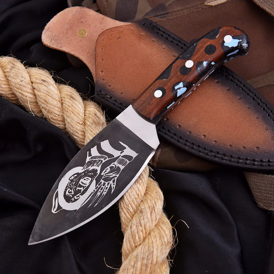 The Freddy Skinner Blade, an improvised shard knife featuring a natural wood and black handle with baby blue resin pieces, showcasing a distinct "Freddy" pattern on the blade.