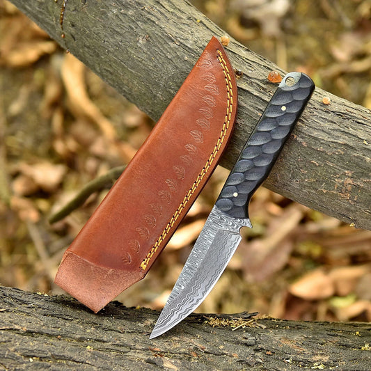 High-quality image of 9’’ handmade custom damascus steel skinner knife with striated black wood handle and leather sheath. bottle opener