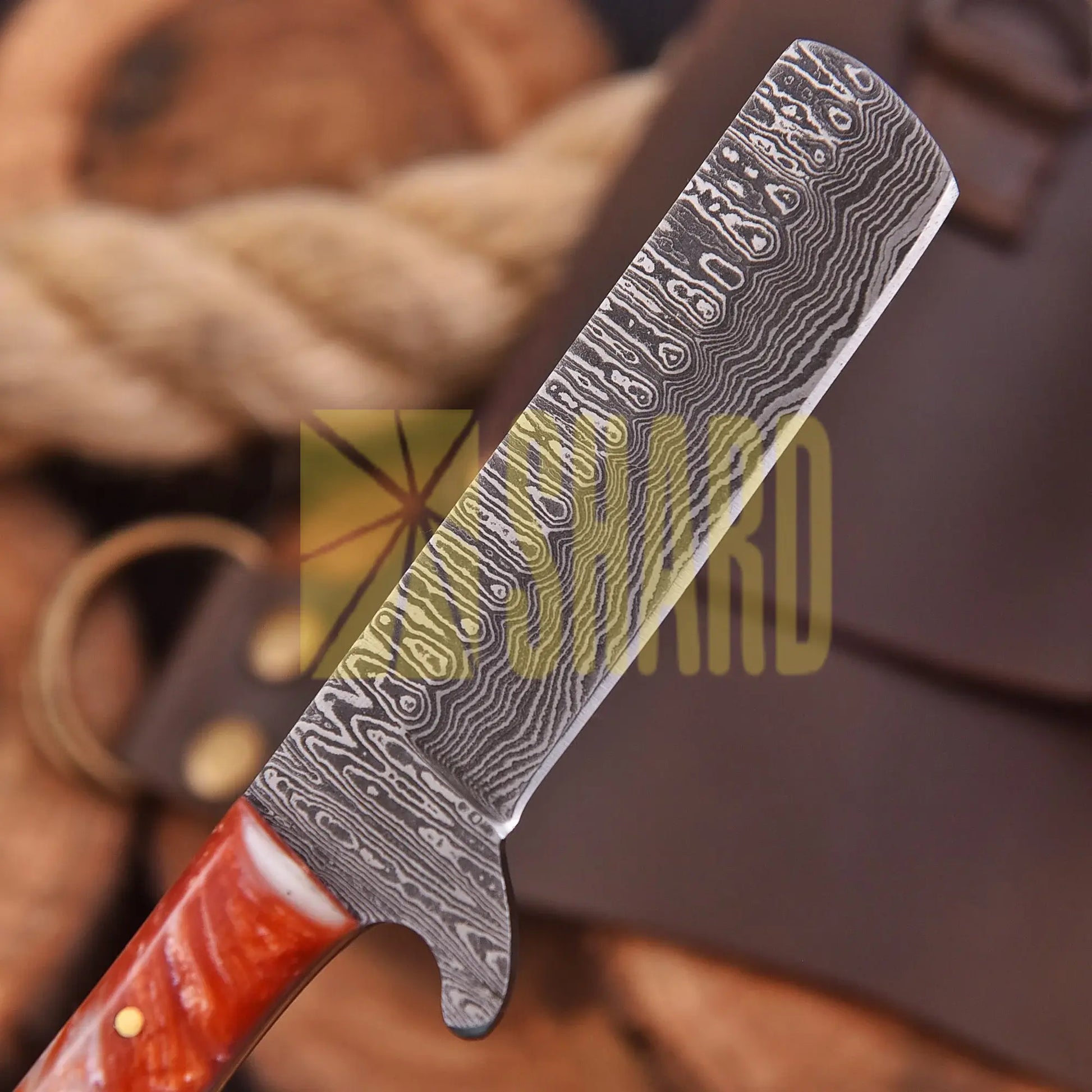 Handcrafted Riverstone Guppy kitchen collectible with Damascus raindrop pattern and stone resin handle