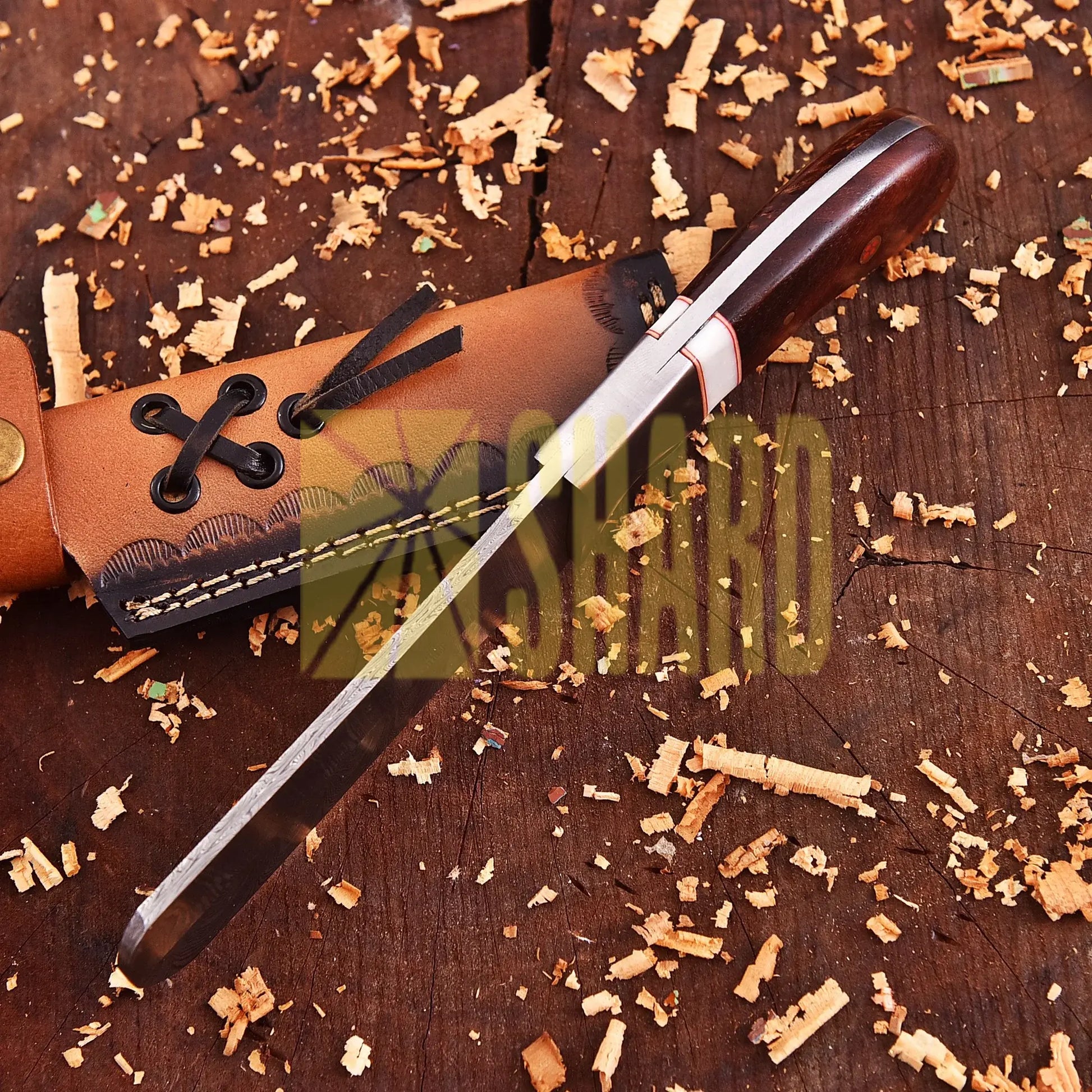 Hand-forged Damascus raindrop steel chef’s tool with steel bolster and Coralfin rosewood handle – Coralfin by Shard Blade